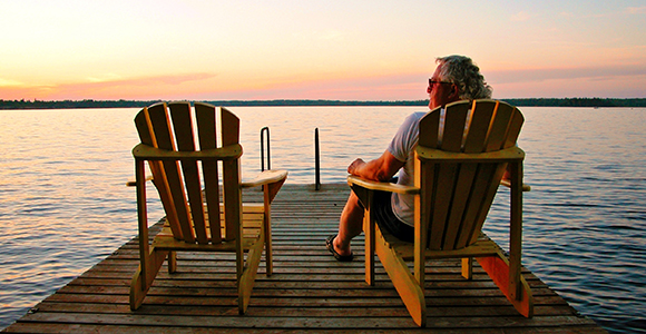 Man at lake watching a sunset